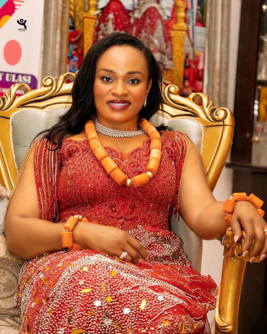 Female guest in traditional red regalia on set
