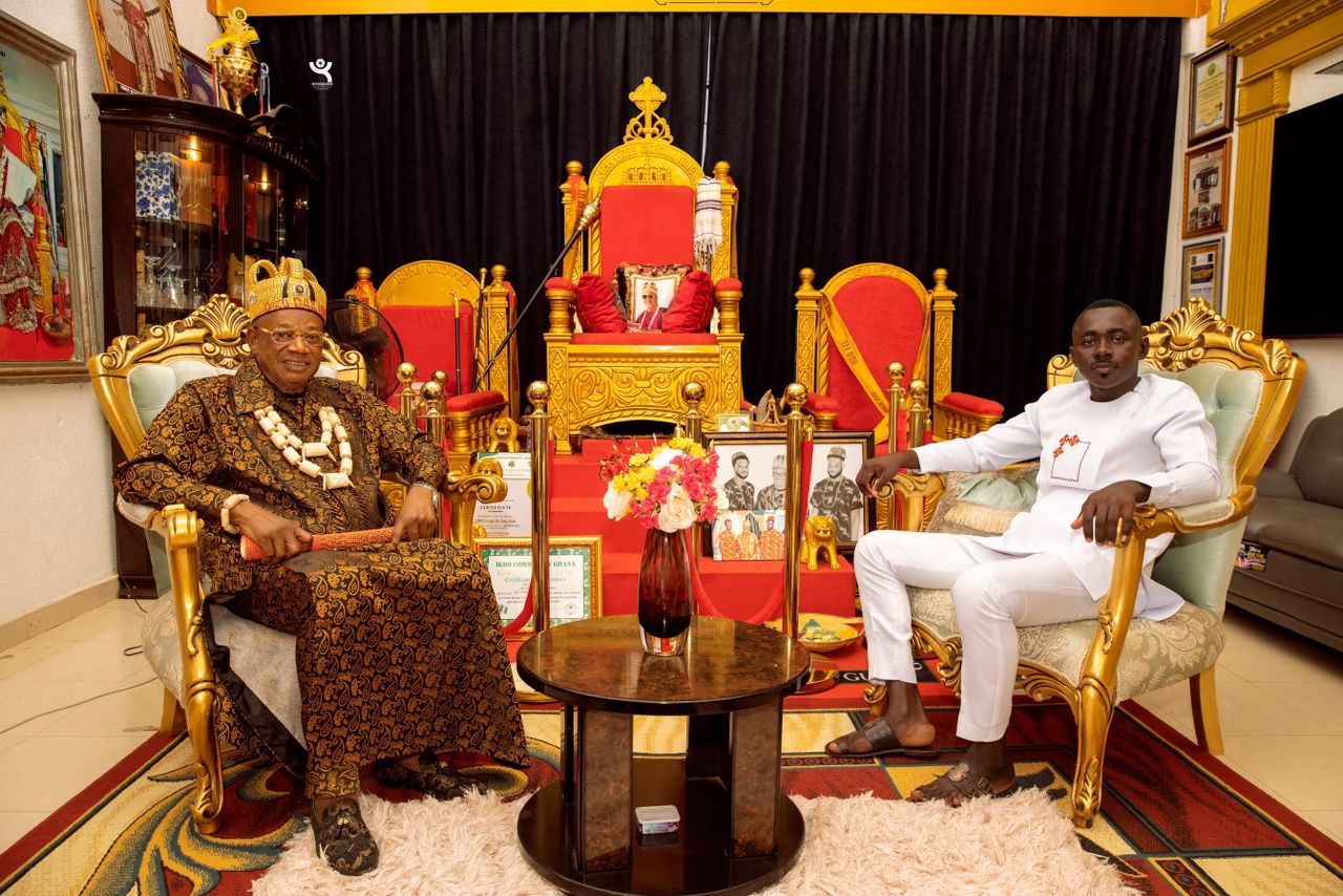 Royal guest in patterned regalia and beaded crown