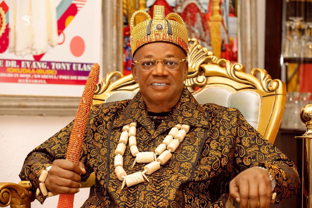Royal guest in golden regalia with ceremonial staff
